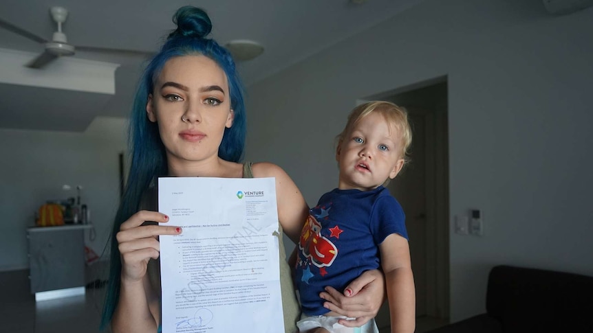 A young woman with blue hair and a small child.