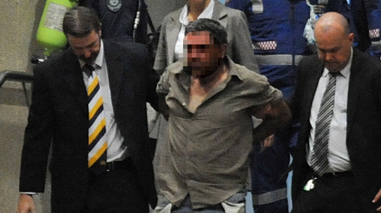 Police remove a man (centre) who they believe held a child hostage in an office in Parramatta.
