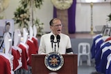 Philippine President Benigno Aquino delivers a speech in front of the caskets of the slain members of the Special Action Force