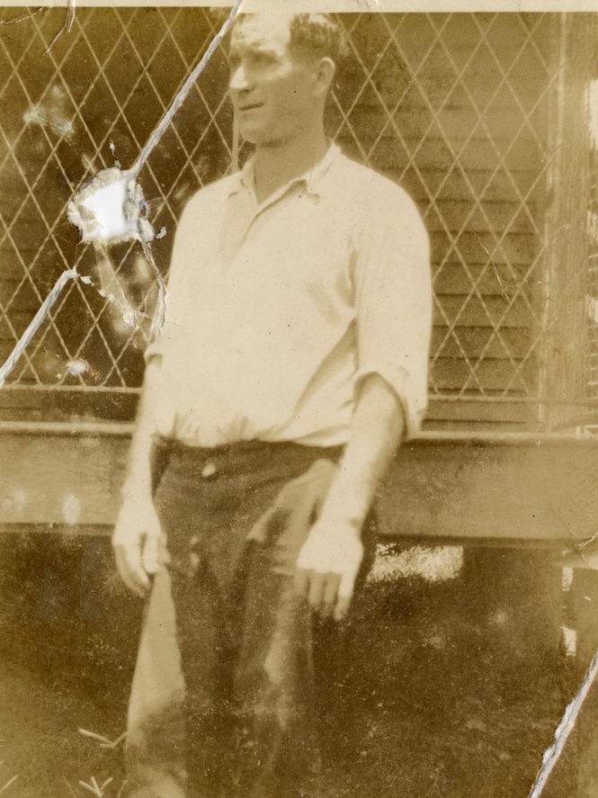 A sepia coloured photo of Nicola Mamone wearing a white shirt and black pants 