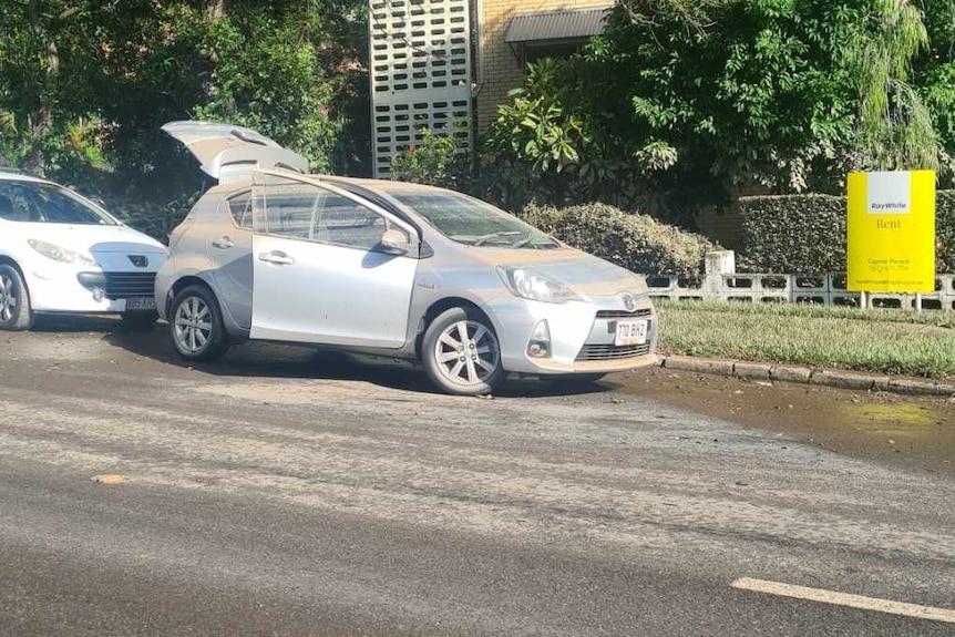 Streetscape with muddied cars parked