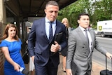 Sam Burgess in a suit arriving at court.