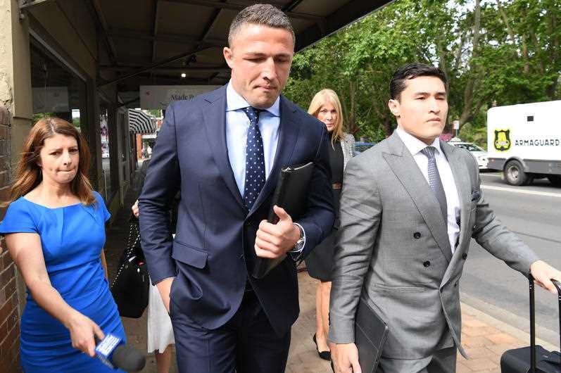 Sam Burgess in a suit arriving at court.