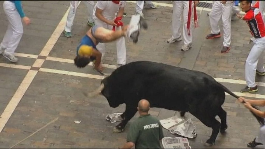 Man gored by bull during Pamplona run.