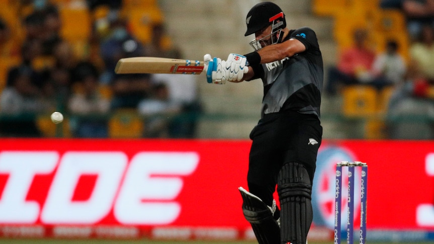 A New Zealand cricketer swings his bat 