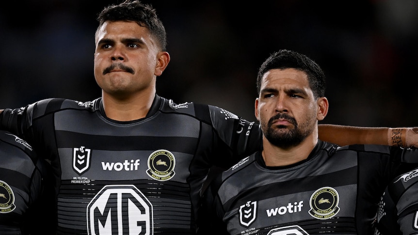 Cody Walker and Latrell Mitchell stand together before a South Sydney NRL match.