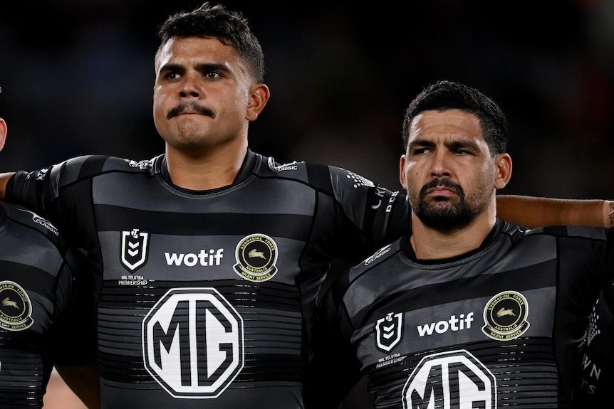 Cody Walker and Latrell Mitchell stand together before a South Sydney NRL match.