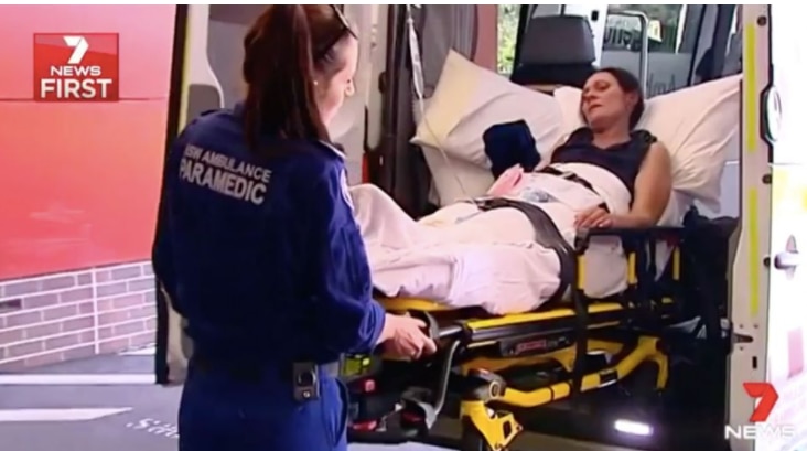 a woman is placed in an ambulance.