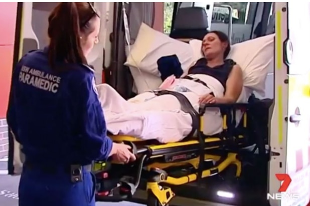a woman is placed in an ambulance.