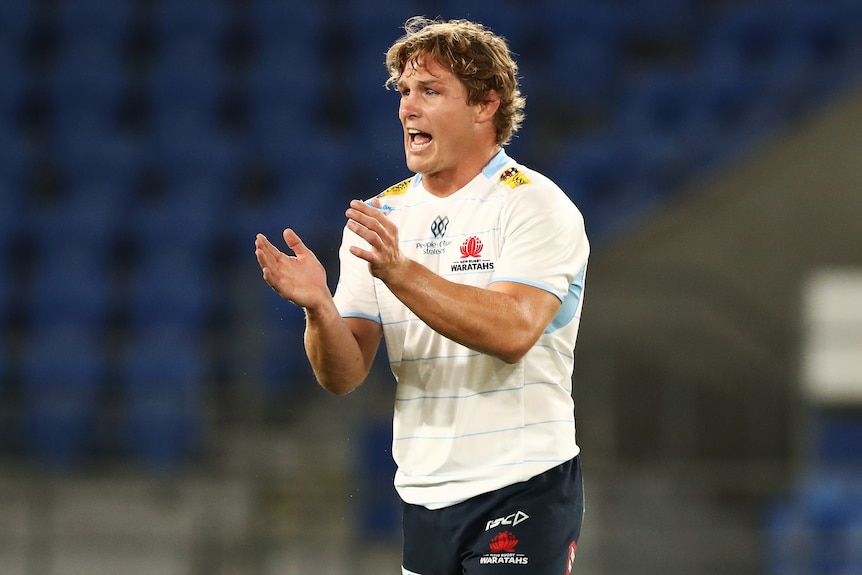 A NSW Waratahs Super Rugby Pacific player claps his hands during a match.