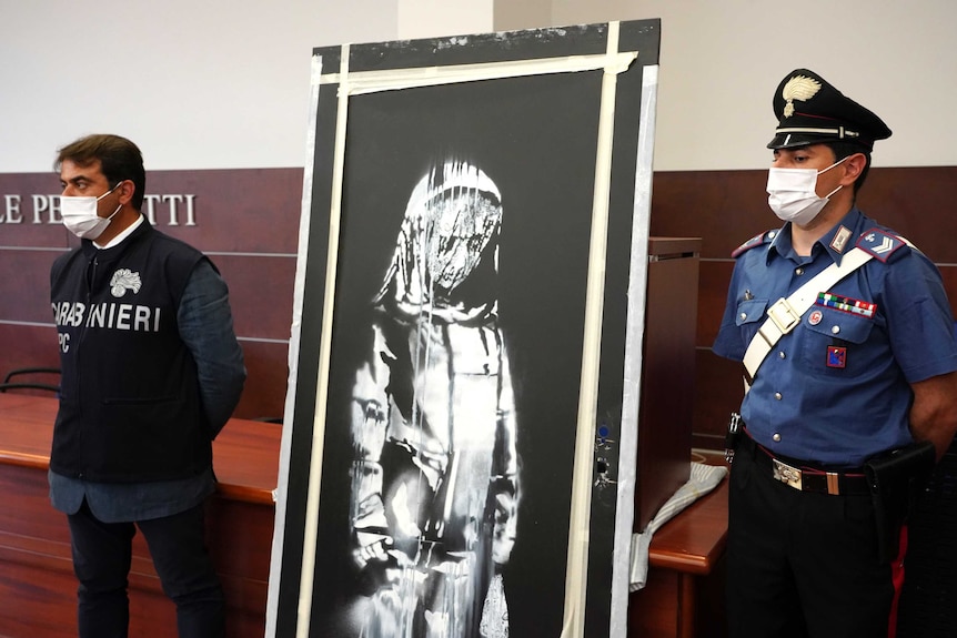 Italian authorities unveil a stolen artwork painted by Banksy as a tribute to the victims of the Bataclan terror attack.