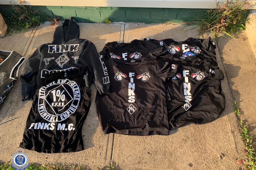Black t-shirts, vests and hoodies with Finks motorcycle gang logos.