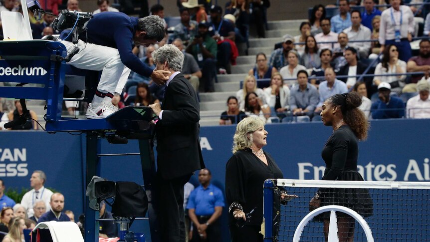Serena Williams speaks to Donna Kelso on court while chair umpire Carlos Ramos speaks to Brian Earley at the US Open.