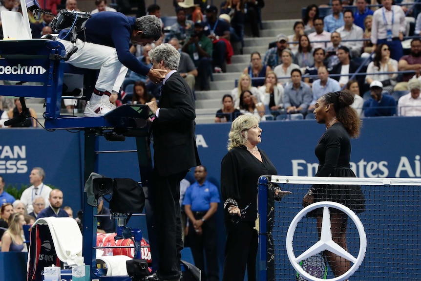 Serena Williams speaks to Donna Kelso on court while chair umpire Carlos Ramos speaks to Brian Earley at the US Open.