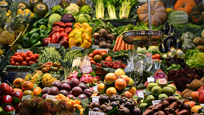 A lush, colourful display of fresh fruit and vegetables at a grocer