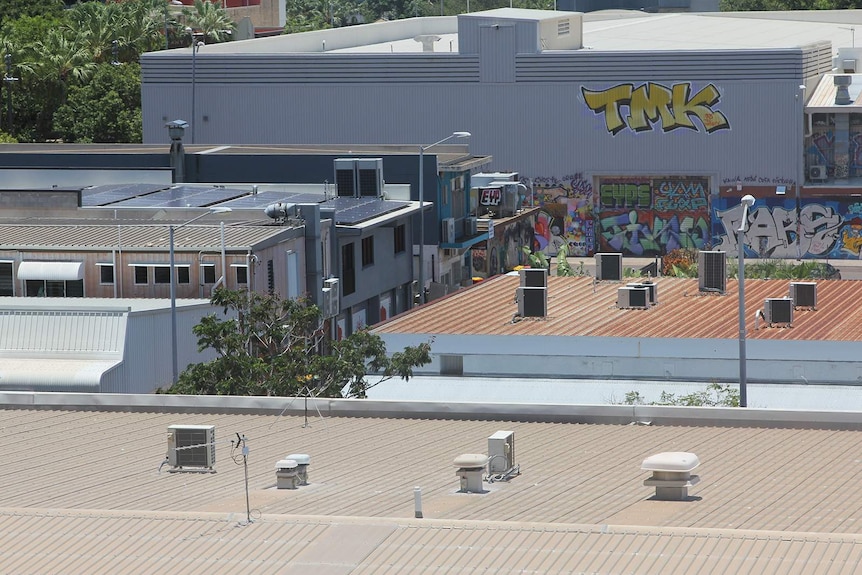 A photo of some air-conditioning units on hot tin roofs in Darwin city.