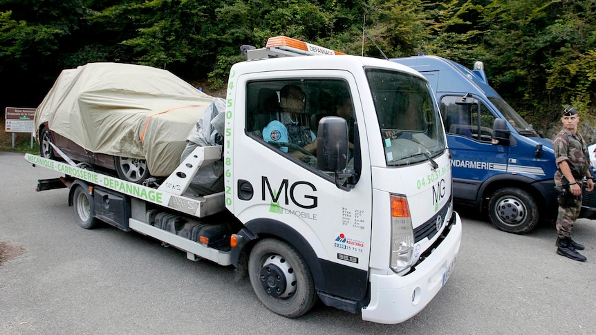 A truck transports a covered British-registered BMW from Chevaline.