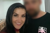 A woman with black hair smiles at the camera, next to a man whose face is pixelated