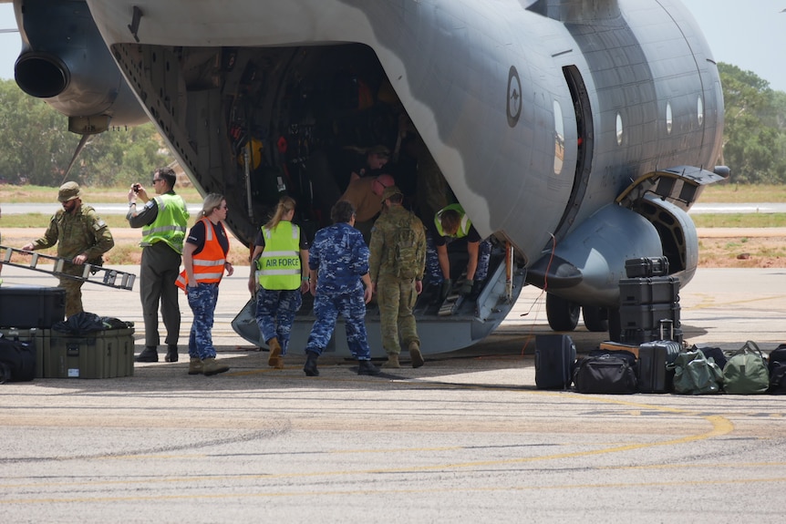 ADF personnel unload a defence force aircraft in Broome.