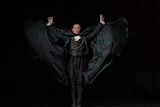 Li Cunxin in cape with arms outstretched dressed as Drosselmeyer in the Nutcracker