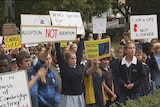 School children hold anti-abortion placards outside Tasmania's parliament.