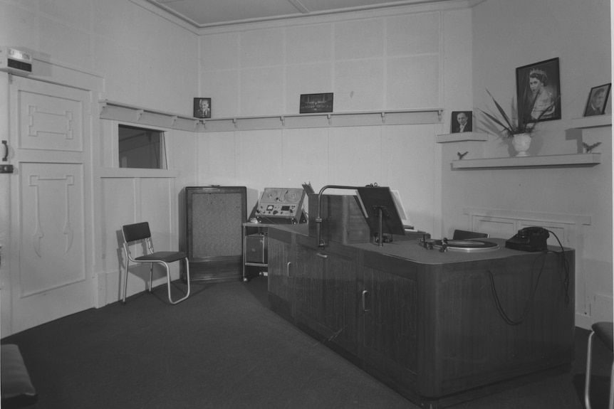 A dim, historic radio studio.