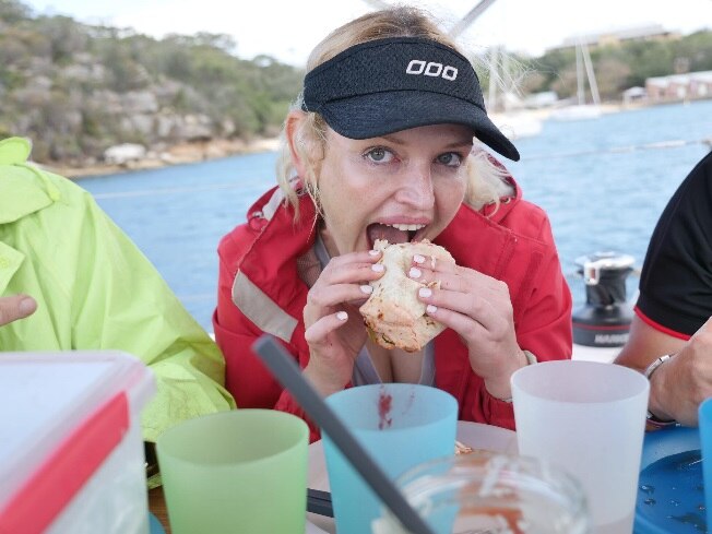 Nicole Rothacker eats a meal seated on a yacht on Sydney Harbour.