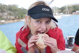 Nicole Rothacker eats a meal seated on a yacht on Sydney Harbour.