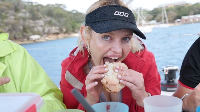 Nicole Rothacker eats a meal seated on a yacht on Sydney Harbour.