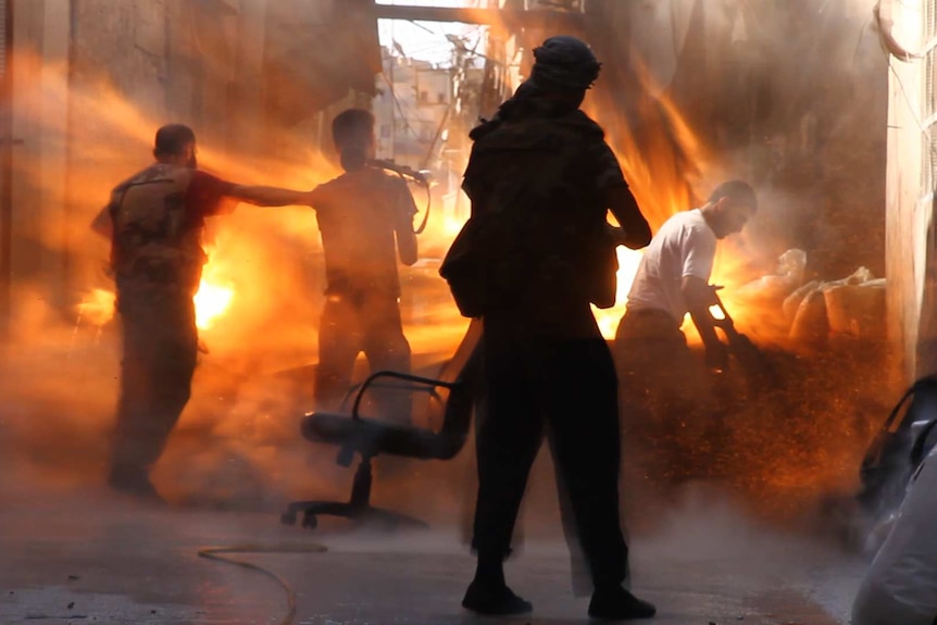 Four men are caught in the middle of a tank blast as fire engulfs their position.