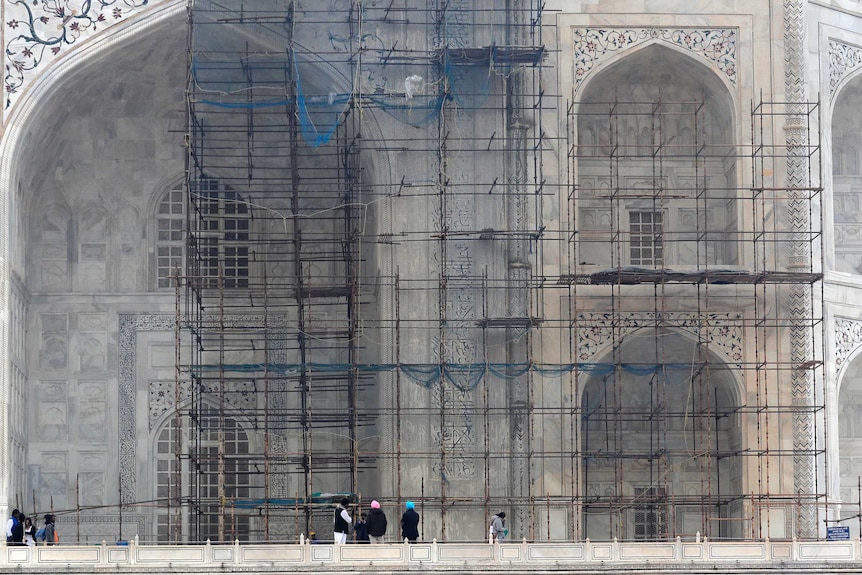 Workers clean the walls of the Taj Mahal