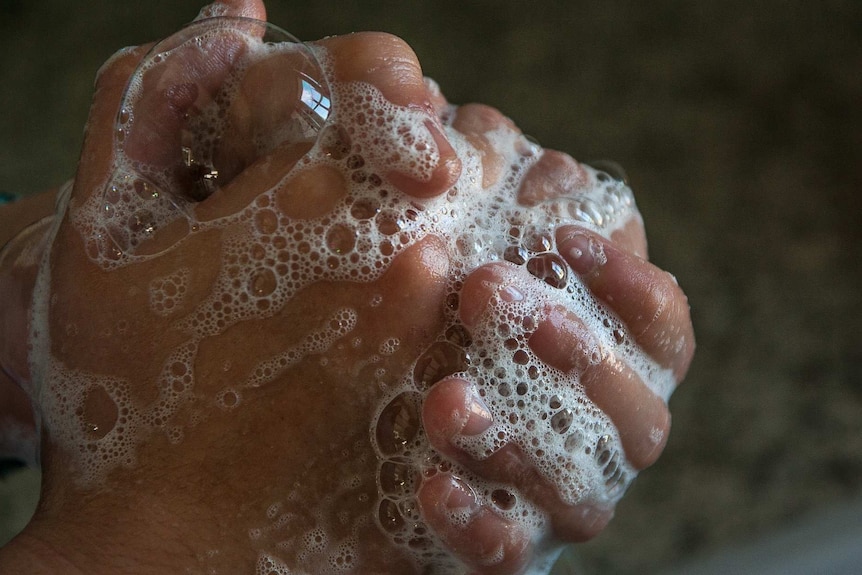 Hands with soapy bubbles