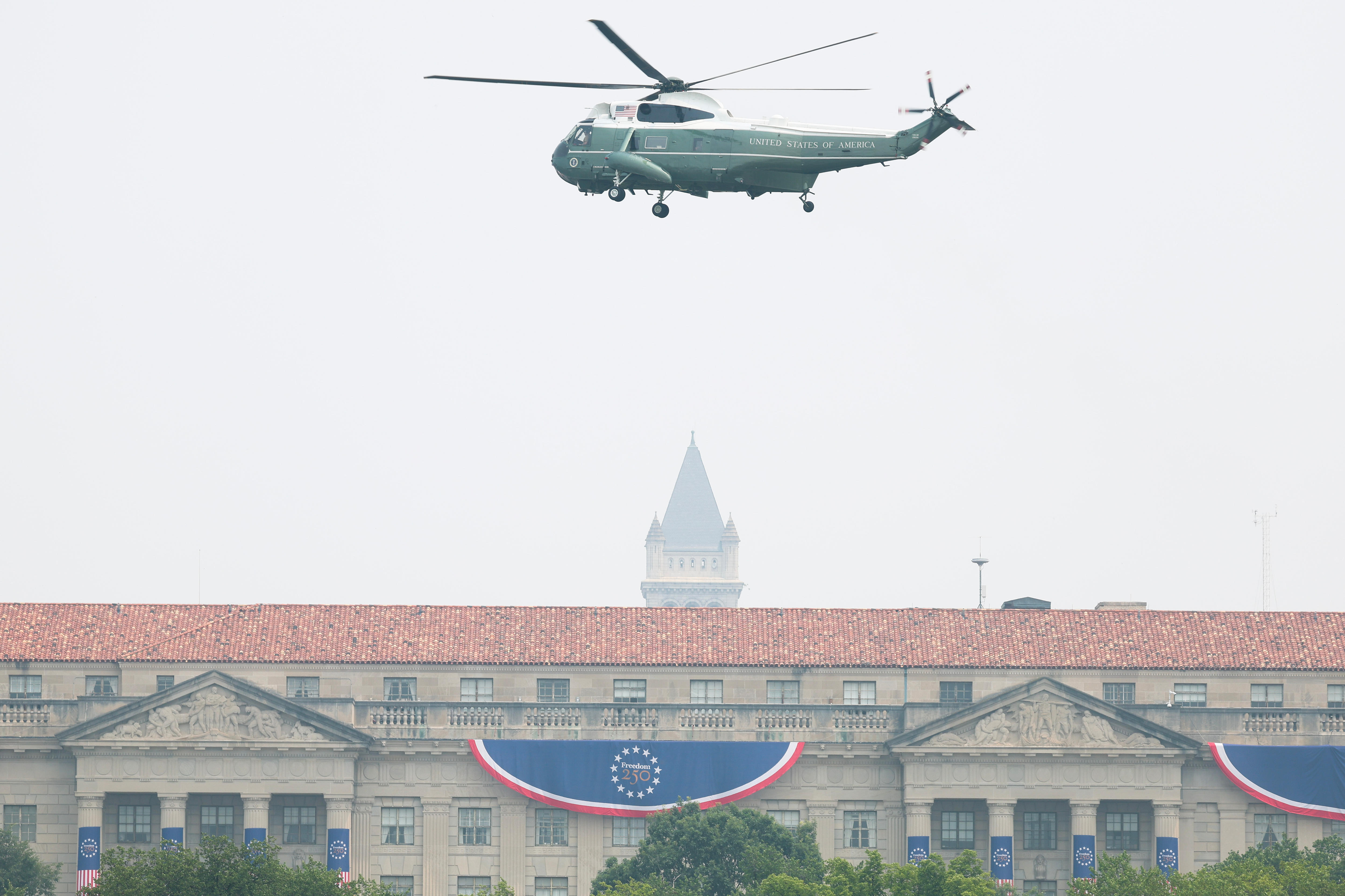 A helicopter rises up in smoky air.