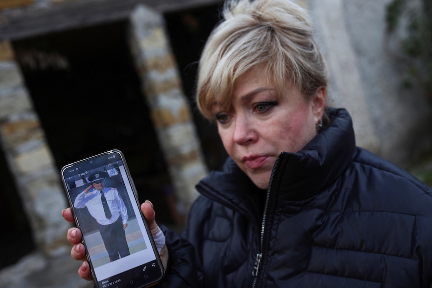 Aliona Lapchuk shows a picture of her husband on her phone.