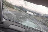 A badly smashed car windscreen.