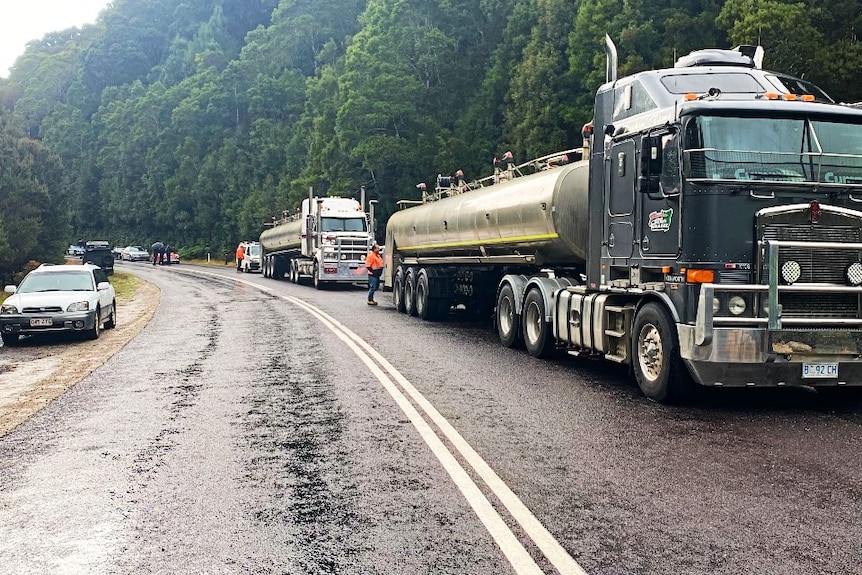 Trucks wait on a road blocked after a Targa crash