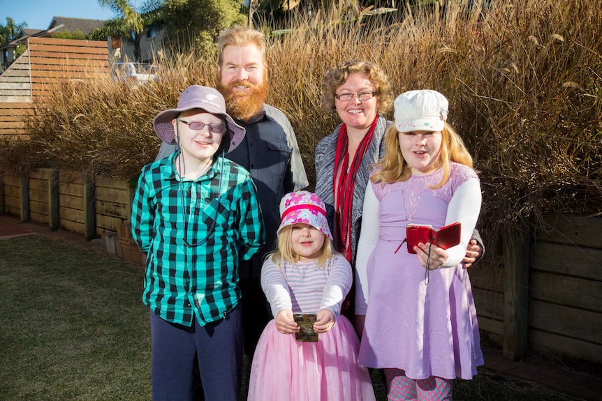 The Russell family stand outside.