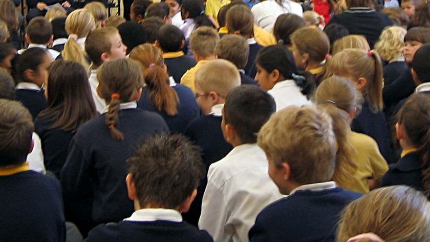 Primary school students sit in an assembly