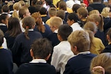 Primary school students sit in an assembly