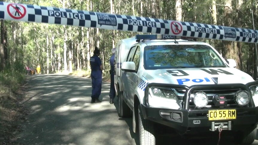 Police at the scene in bushland near Taree