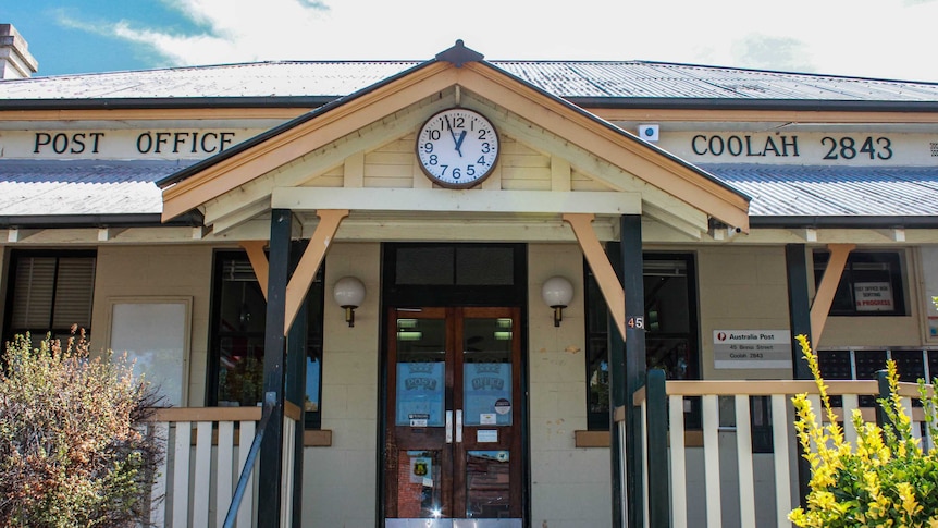 Front of the heritage timber Post office building of Coolah with clock