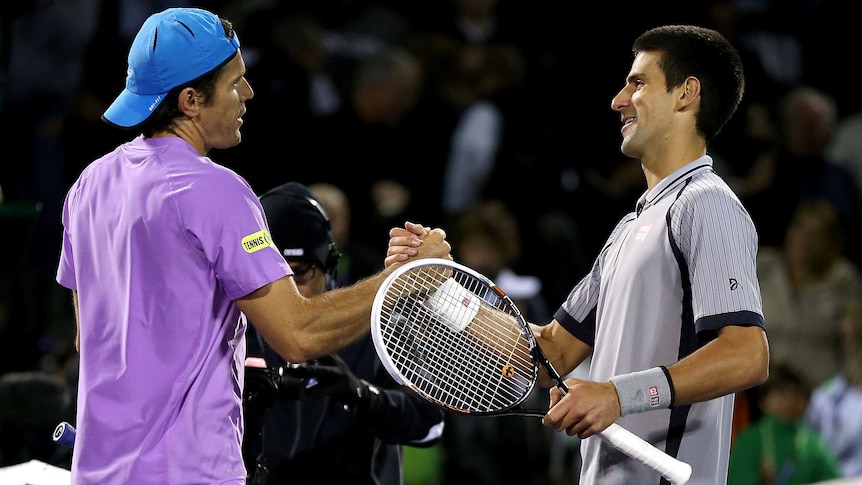 Tommy Haas of Germany is congratulated by Novak Djokovic