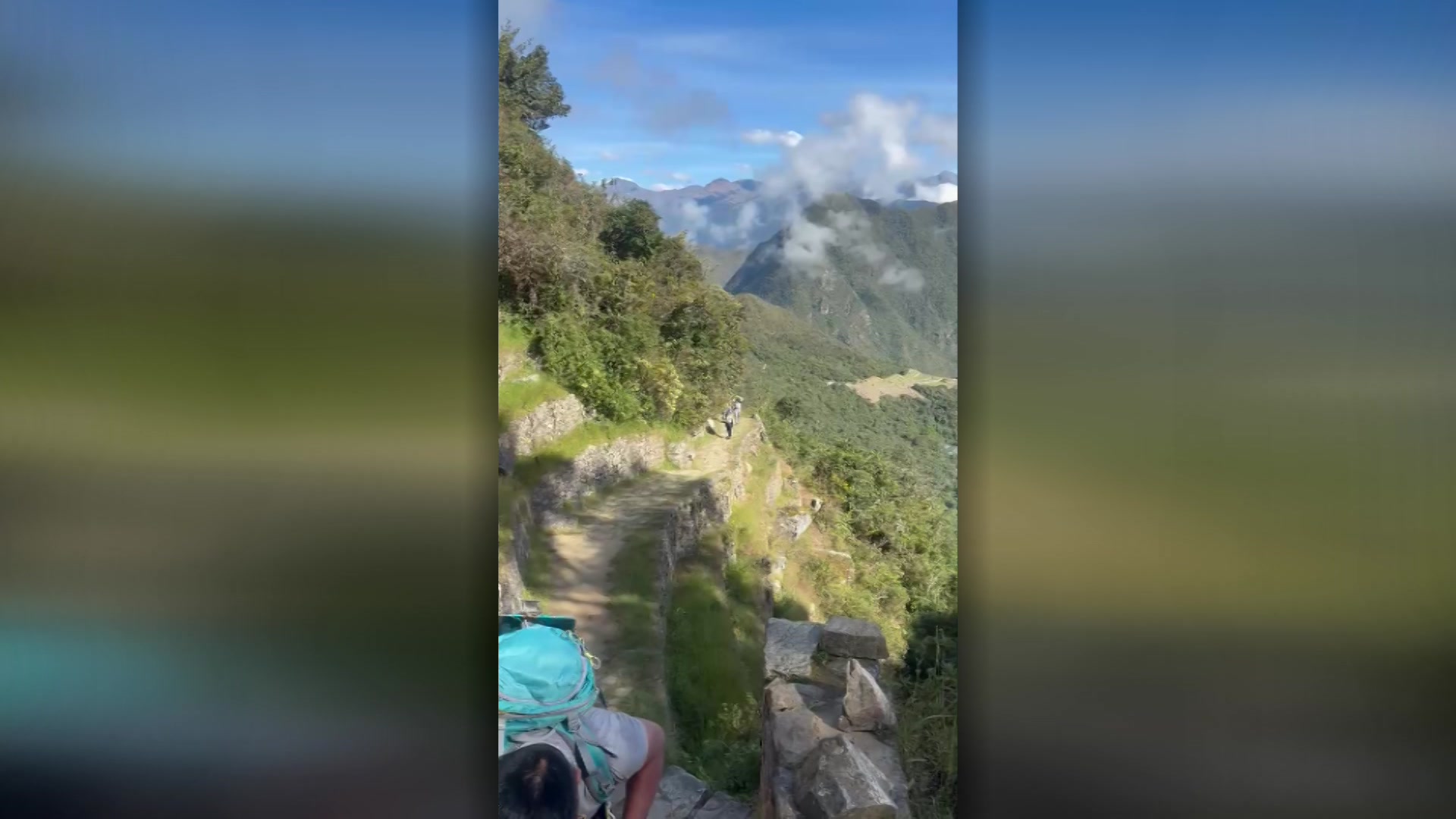 Peru landscape. Blue sky with white clouds. Mountain trial. Green mountains and rocky outcrops. 