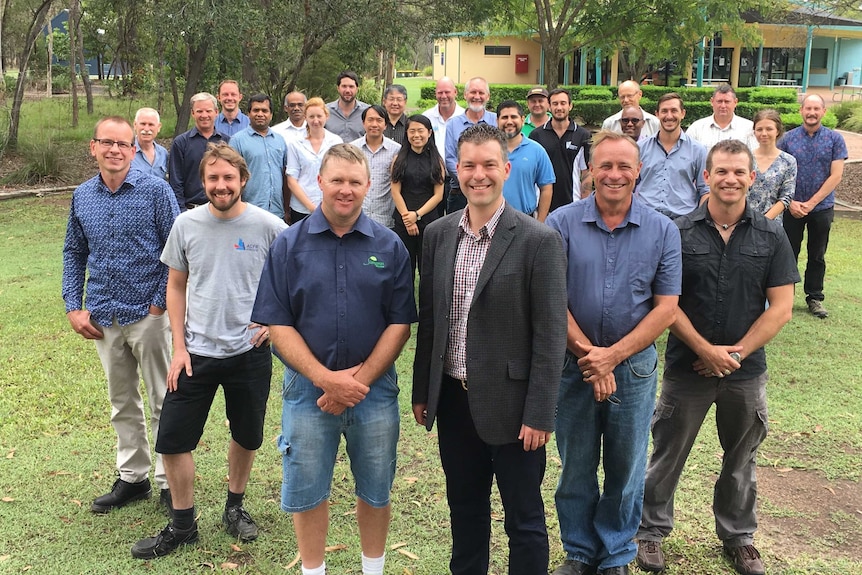 A group of 26 people standing outside