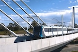 A train travels on an elevated line.