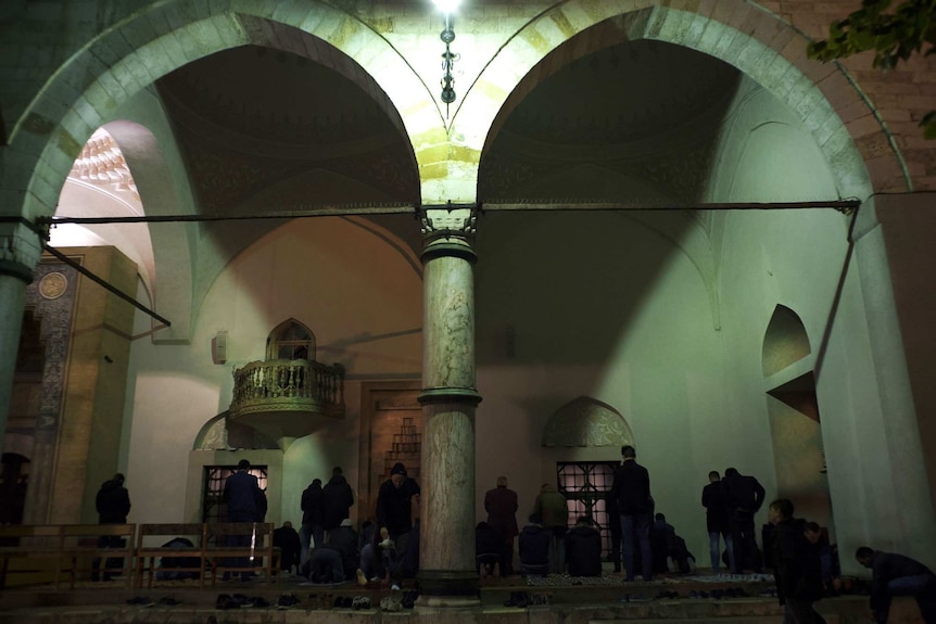 Muslims pray outside a centuries-old Ottoman mosque in Sarajevo.