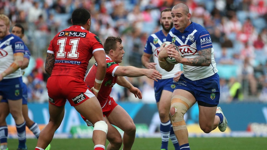 David Klemmer of the Bulldogs (R) runs the ball against the Dragons on June 12, 2017.