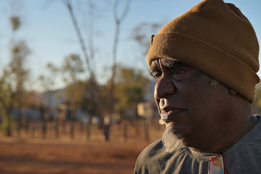 Douglas Multa wearing a brown beanie in Haasts Bluff.