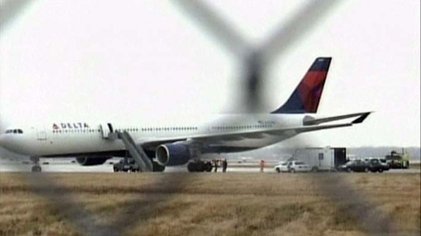 A Delta Airlines jet sits on the tarmac in Detroit, Michigan, after a passeger let off fireworks