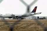 A Delta Airlines jet sits on the tarmac in Detroit, Michigan, after a passeger let off fireworks